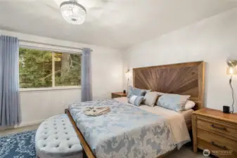 Primary suite with large windows bringing in abundant natural light