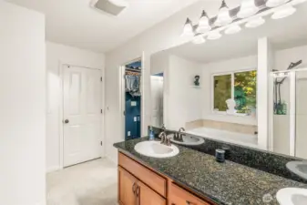 Five-piece primary bath with soaking tub, double vanity, and separate shower