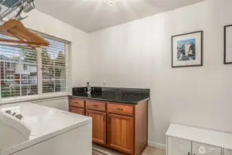 Laundry room with shelving and extra storage