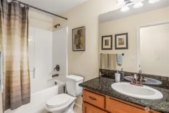 Well-maintained full upper-level bath with neutral finishes and ample counter space serving the secondary bedrooms.