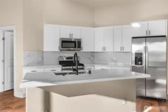 Enjoy hosting all your guests in this brand new kitchen! New cabinets, quartz countertops and backsplash.