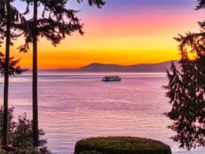 Enjoy ferries moving through Thatcher Pass beneath unforgettable sunsets.