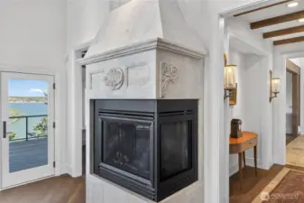 An imported Italian stone surround gives the family room fireplace presence and artistry, creating a striking focal point.  Note the detail in the custom surround.  All 8 fireplaces are natural gas.
