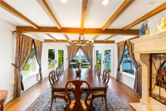 The formal dining area combines natural wood accents with generous space and a large fireplace, offering a warm and welcoming setting for memorable meals.