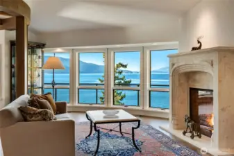 Imported Italian stone surrounds one of eight fireplaces, anchoring a living space with uninterrupted views.