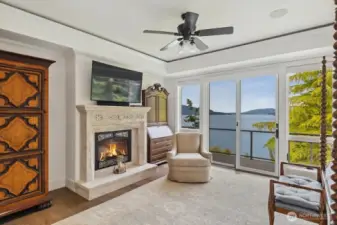 The private wing consists of the primary bedroom is a true retreat with a fireplace, expansive windows, deck, and sweeping views that make the water feel within reach.