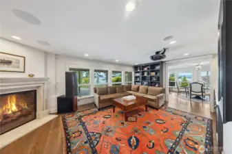 A state-of-the-art media room includes a motorized drop-down screen, projector, and wet bar for immersive cinematic experiences.