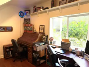 Off of the family room is an office or the 4th bedroom. Large window to watch wildlife and the waterfall. Door enters into the downstairs 3/4 bath.