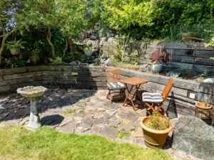 On the northwest corner is a patio and waterfall. Terrance landscaping.