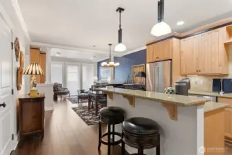 The kitchen is thoughtfully appointed with slab granite countertops, stainless steel appliances, New Double oven, a wine fridge, and under-mount lighting.