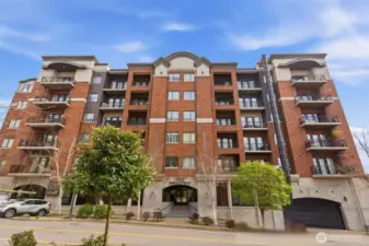 Welcome to Unit 704 at 505 Broadway, where timeless craftsmanship, elevated amenities, and refined living spaces come together to define luxury in Tacoma’s coveted Down town District. This beautifully maintained residence showcases a spacious, well-designed floor plan featuring a generous primary bedroom, versatile den, and an open-concept living and dining area ideal for both everyday living and entertaining. High ceilings, rich hardwood flooring, and elegant architectural details create a warm yet sophisticated ambiance, while the inviting living room centers around a cozy gas fireplace. The kitchen is thoughtfully appointed with slab granite countertops, stainless steel appliances, New Double oven, a wine fridge, and under-mount lighting. Residents of 505 Broadway enjoy an impressive collection of amenities including a stunning Sky Lounge with views of Commencement Bay and Mt. Rainier, a fitness center, hobby/game room, secure parking, and additional storage.