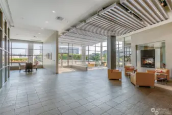 The glass walled Esplanade lobby is anchored by a gas fireplace shown to the right.