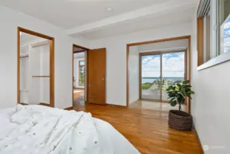 The primary suite also takes in those views and has a sitting room that opens onto the wraparound deck. There is a large walk-in closet to the left that opens to the 3/4 bath.