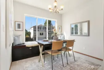 Bright dining room offers built-in storage bench.