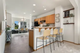 Breakfast bar overlooks kitchen & dining space.