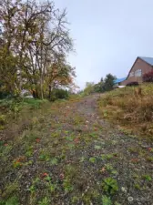 Property tucks below road and hidden away.