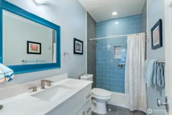 Full bath fully renovated with walk-in shower, beautiful tiling and quartz countertop off the kitchen, next to Utility Room and Bedroom #3.