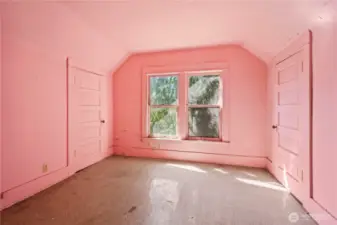 This pink room is the second bedroom in the upper level.