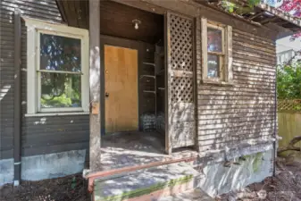 Out of the back door of the home is the level and open backyard, offering potential space for a larger new build.