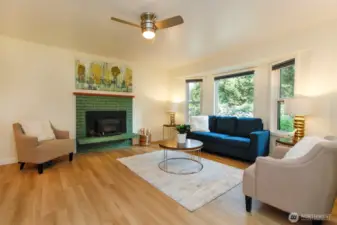 Open Living room with wood stove, new floors and paint