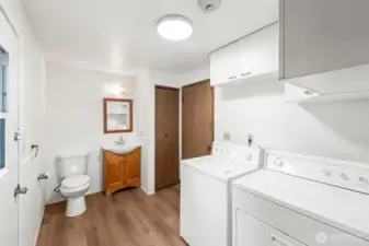 Half bath with laundry room, garage door, and patio door with pet access.