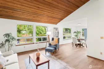 The living room flows into the sunny dining room.