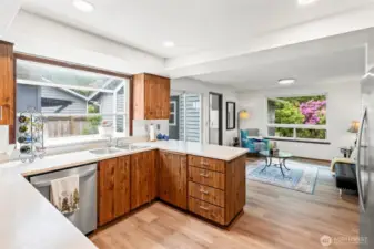 Updated kitchen features a large sunny solarium window.