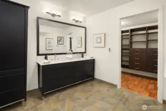 Primary has a large dual vanity and big walk in closet
