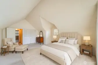 Primary bedroom with vaulted ceilings and private deck. Photo is virtually staged.