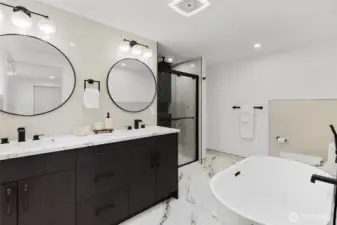 Primary bath with soaking tub, spacious shower, heated floors and quartz counters