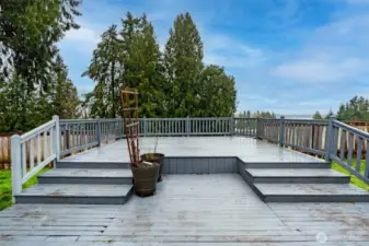 Tiered deck has so much room for outdoor dining space and conversation area overlooking the lake.