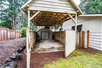Boathouse and shed tucked away on side of yard.