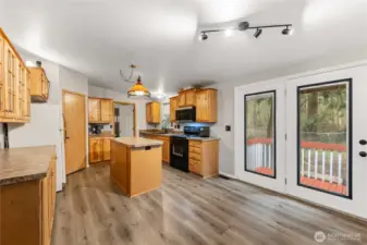 Light and bright kitchen with island and french doors to the bachyard