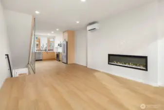 great sized living room with cozy fireplace and ample room for dining table