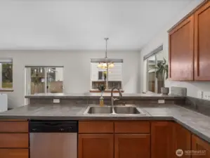 Abundant counter space and open concept flow into the dining room. New faucet in the kitchen sink.