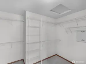 Generously sized primary walk-in closet designed for effortless organization and everyday convenience.