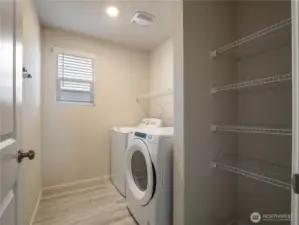The convenient utility room, complete with washer and dryer, offers lots of storage options and is located just inside from the garage.