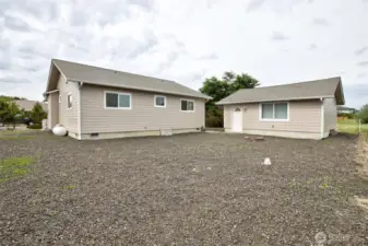 Back yard view of the house and two car garage.