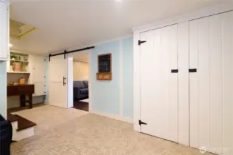 At the bottom of the steps is the door leading into the media/rec room.