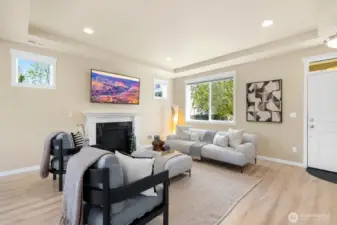 Main living room offers ample natural light, great space & cozy gas fireplace.