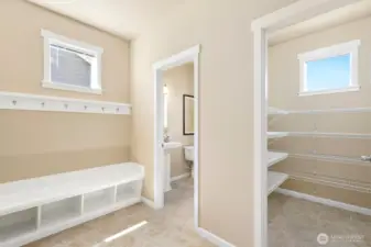 Mud room, pantry & half bath sit off garage entrance.