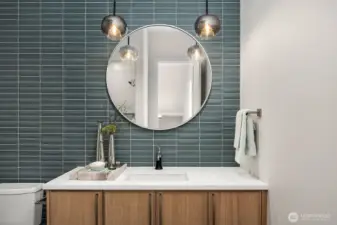 This stunning Powder Bath, conveniently located on the main level, offers both style and practicality with abundant cabinet storage space, making it as functional as it is beautiful. This Bathroom also includes a shower so your Office can also double as another Guest room if needed.