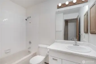 Light and bright main bathroom.