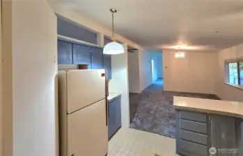 Kitchen looking to the dining and family beyond.