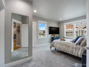 The primary suite is roomy and serene.