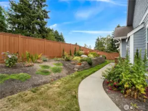 Lovely landscaping with floral and brush adorns the raised flowerbeds.