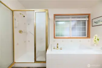 Primary bath with jetted tub and double sink vanity.