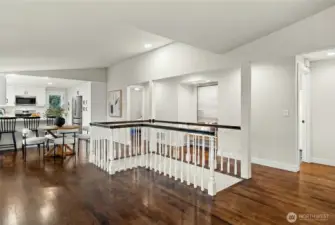 Spacious upstairs with bright open layout and stair railing feature.