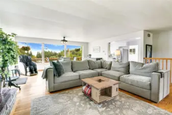 This open floor plan invites versatile living, from lively gatherings to cozy quiet moments—all set against a backdrop of tranquil views framed by sunlit windows.