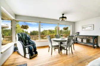 Whether hosting a dinner party or enjoying a quiet meal, there’s plenty of space to dine in comfort—all while taking in peaceful views through updated picture windows that frame the natural beauty beyond.